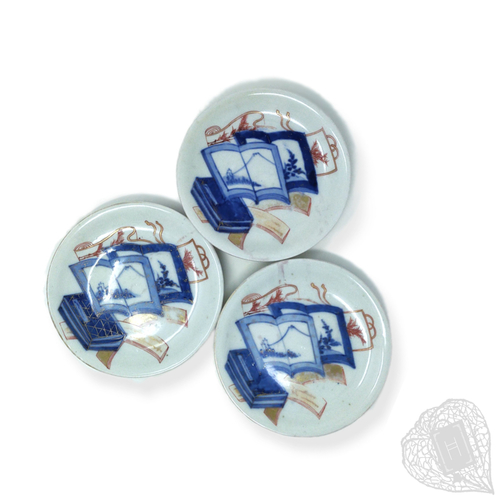 Three Plates with Book Patterns A Set of Three Plates with Book Motifs
